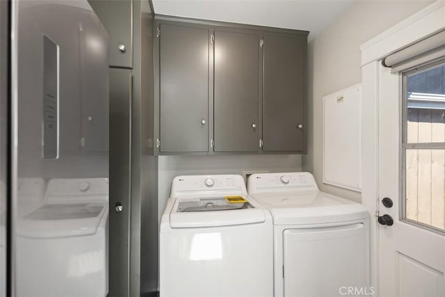 laundry area featuring cabinet space and separate washer and dryer