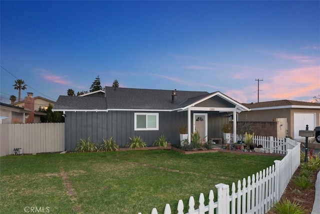 view of front of home featuring a yard, board and batten siding, and a fenced backyard