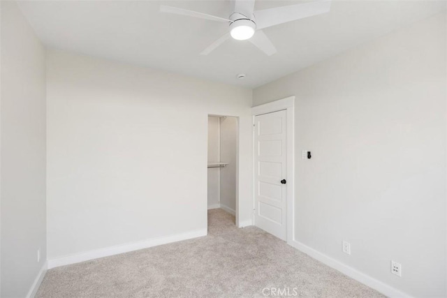 unfurnished bedroom featuring carpet floors, a closet, ceiling fan, and baseboards