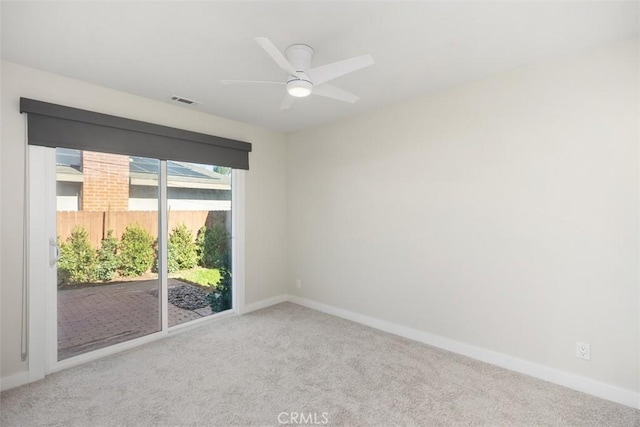 unfurnished room with carpet flooring, ceiling fan, and baseboards