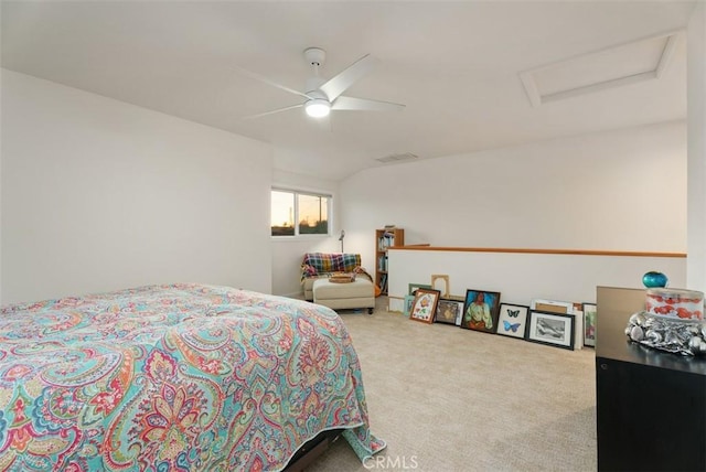 carpeted bedroom featuring visible vents, ceiling fan, and attic access