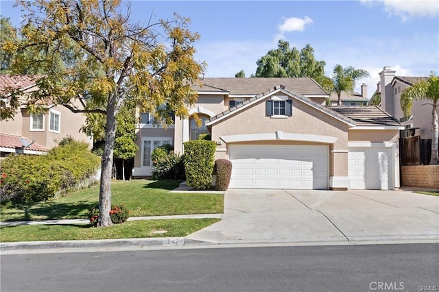 view of front of home with a garage, a tile roof, concrete driveway, stucco siding, and a front yard