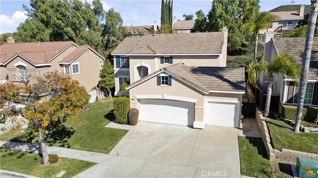 view of front facade with an attached garage, concrete driveway, a tiled roof, stucco siding, and a front yard