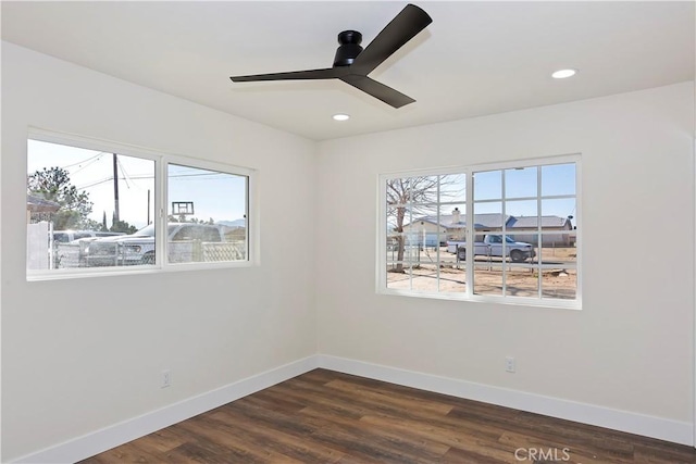 spare room featuring baseboards, dark wood finished floors, a ceiling fan, and recessed lighting