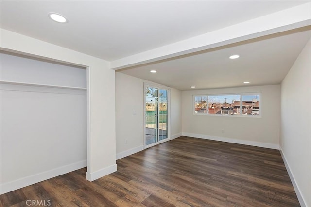 interior space with baseboards, recessed lighting, wood finished floors, and access to exterior