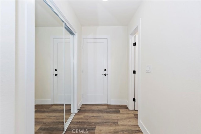 interior space featuring wood finished floors and baseboards