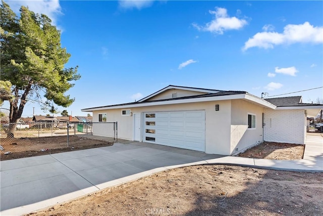 single story home featuring a garage, brick siding, fence, concrete driveway, and stucco siding