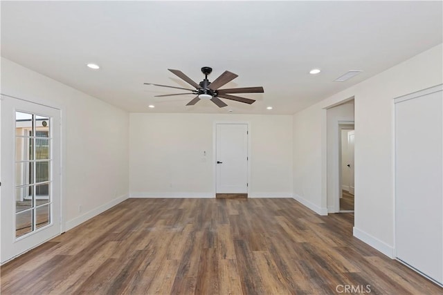 spare room featuring recessed lighting, visible vents, a ceiling fan, wood finished floors, and baseboards