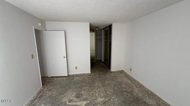 unfurnished bedroom featuring a textured ceiling