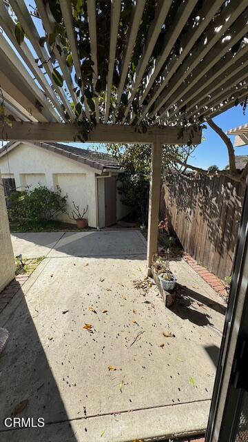 view of patio / terrace featuring fence and a pergola