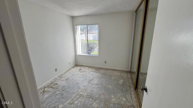 unfurnished bedroom with a textured ceiling