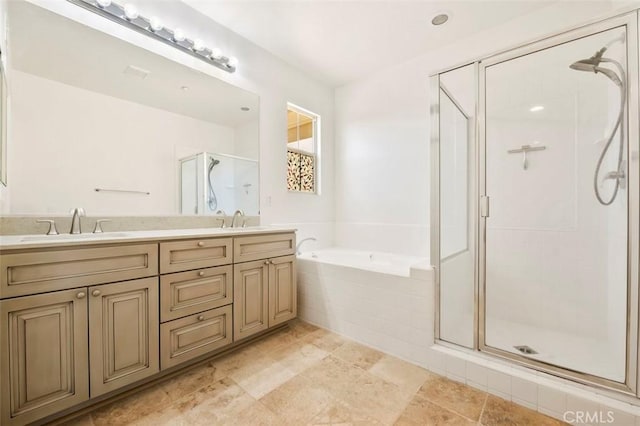 bathroom featuring a stall shower, a garden tub, a sink, and double vanity