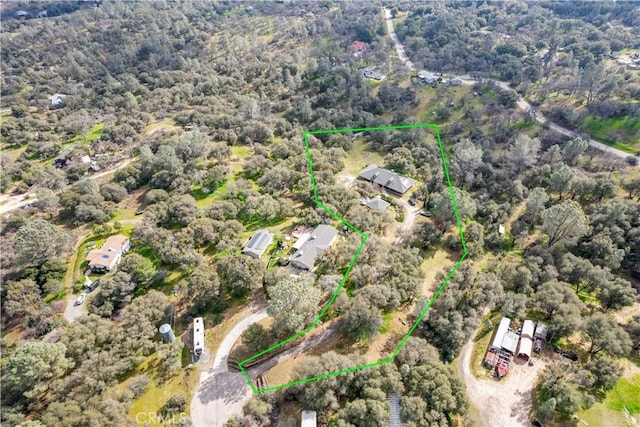 drone / aerial view featuring a wooded view