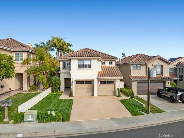 mediterranean / spanish house featuring driveway, a garage, a tiled roof, a front lawn, and stucco siding