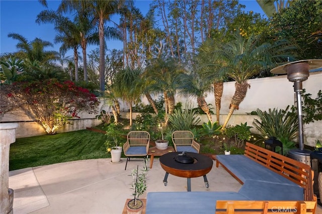 view of patio with an outdoor fire pit and fence