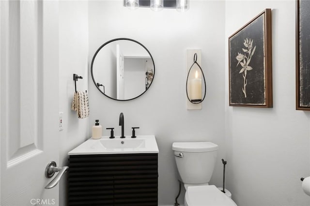 half bath featuring toilet and vanity