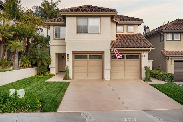 mediterranean / spanish house with a tile roof, stucco siding, concrete driveway, an attached garage, and a front yard