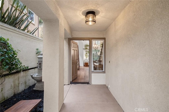 view of exterior entry featuring stucco siding