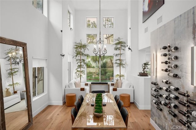 sunroom / solarium with visible vents and a notable chandelier