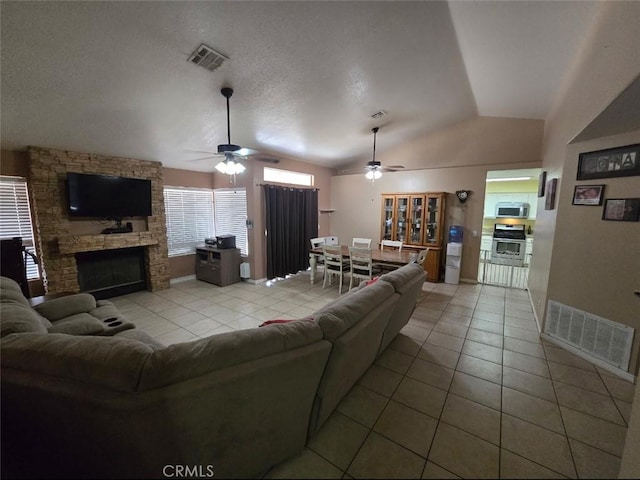 living room with tile patterned flooring, visible vents, and a ceiling fan