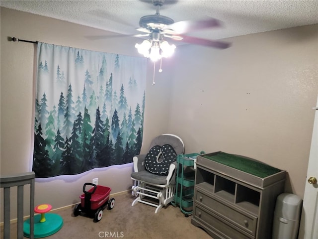 bedroom featuring carpet floors, a textured ceiling, and a ceiling fan