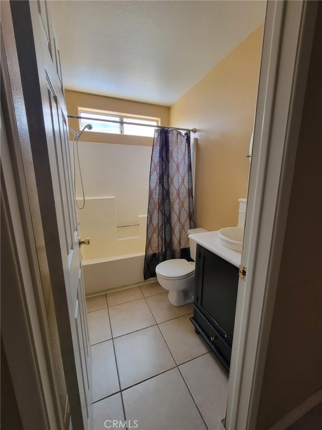 full bath featuring shower / bath combo, vanity, tile patterned flooring, and toilet