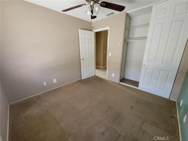 unfurnished bedroom featuring a closet, ceiling fan, carpet, baseboards, and visible vents