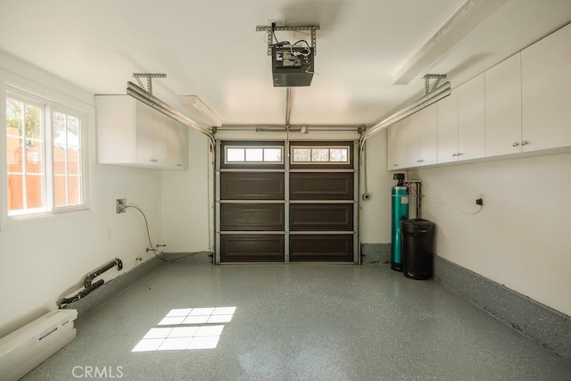 garage featuring a garage door opener and baseboard heating