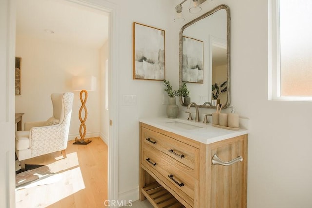 hall featuring light wood-style flooring and a sink