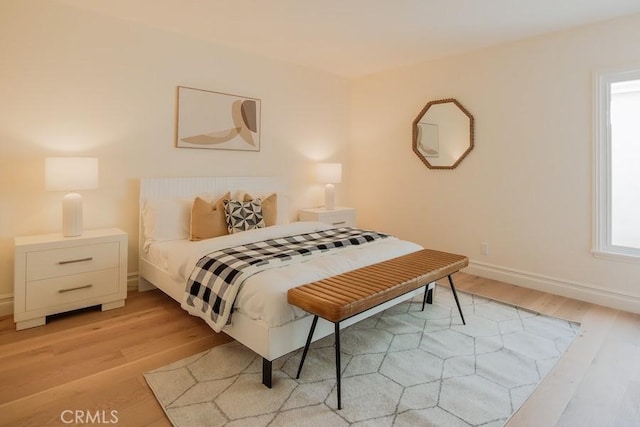 bedroom featuring light wood-type flooring and baseboards