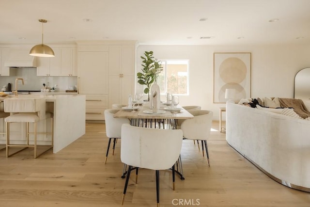 dining area with recessed lighting and light wood-style floors