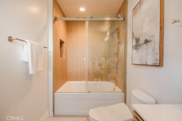 bathroom featuring vanity, toilet, and combined bath / shower with glass door