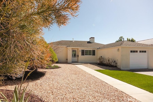 ranch-style home featuring a shingled roof, a garage, and stucco siding