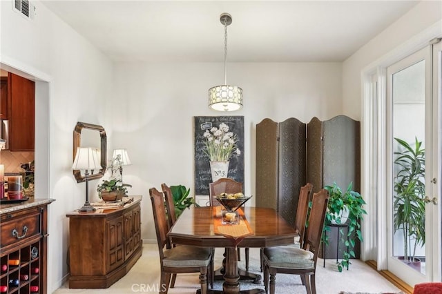 dining space with plenty of natural light and visible vents