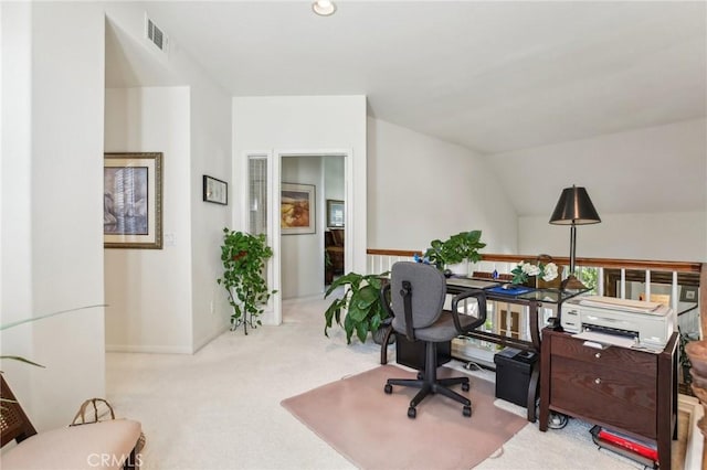 carpeted office featuring lofted ceiling, baseboards, and visible vents