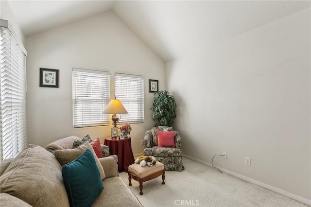 living area featuring baseboards, vaulted ceiling, and carpet flooring