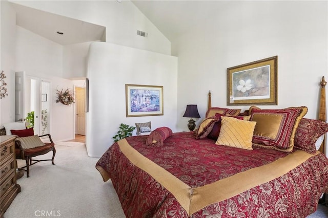 bedroom with carpet floors, high vaulted ceiling, and visible vents