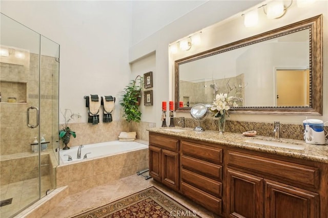 full bath featuring double vanity, a stall shower, a sink, and a bath