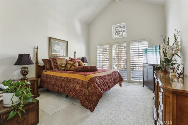 bedroom featuring access to outside, high vaulted ceiling, and light colored carpet