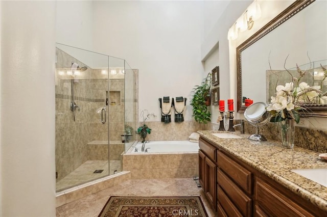 full bath with double vanity, a stall shower, a sink, a bath, and tile patterned floors