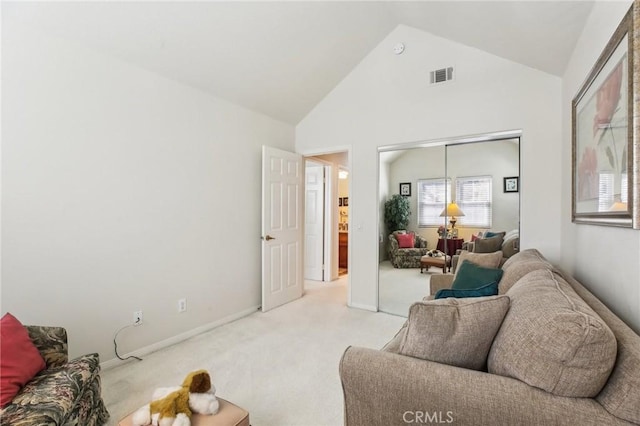 living area with high vaulted ceiling, visible vents, light carpet, and baseboards