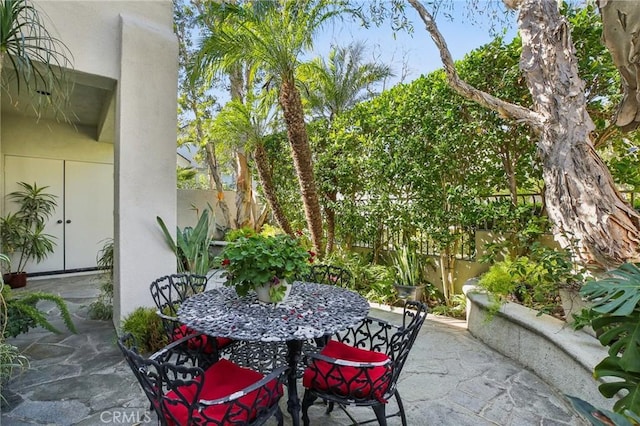 view of patio / terrace featuring outdoor dining space and fence