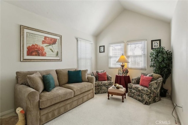 living area with carpet floors and vaulted ceiling