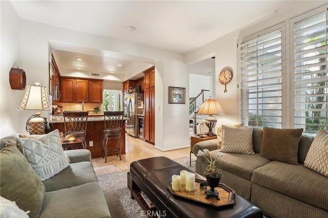 living area featuring stairway and recessed lighting