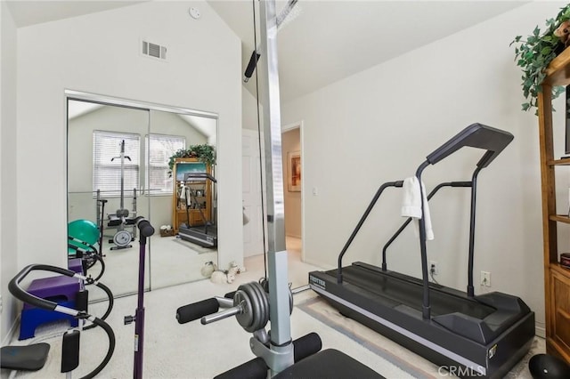 exercise area featuring lofted ceiling and visible vents