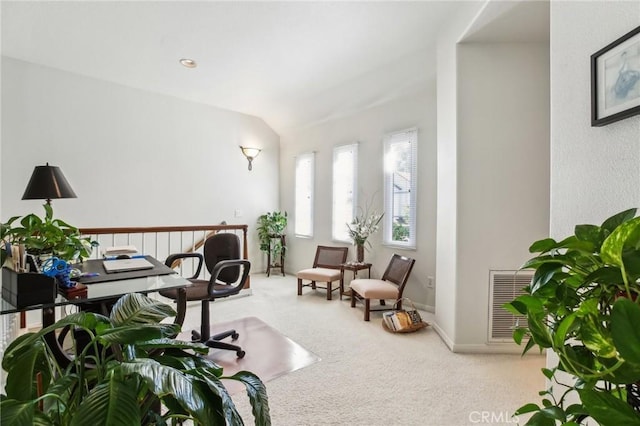 carpeted office featuring lofted ceiling, visible vents, and baseboards