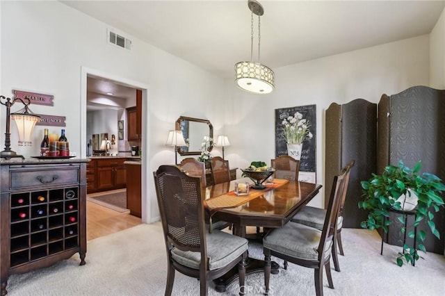 dining room with light carpet and visible vents