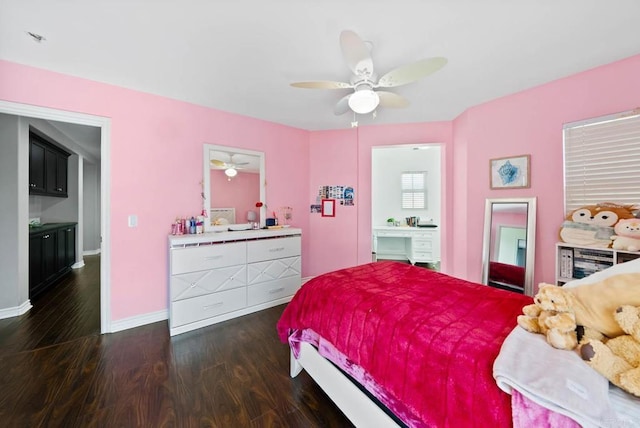 bedroom featuring baseboards, connected bathroom, ceiling fan, and dark wood-style floors
