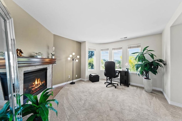 office space featuring visible vents, a fireplace, baseboards, and carpet floors