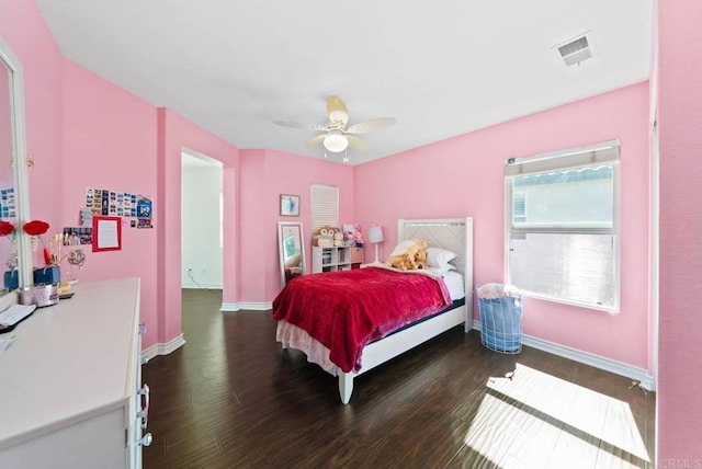 bedroom with visible vents, baseboards, a ceiling fan, and wood finished floors